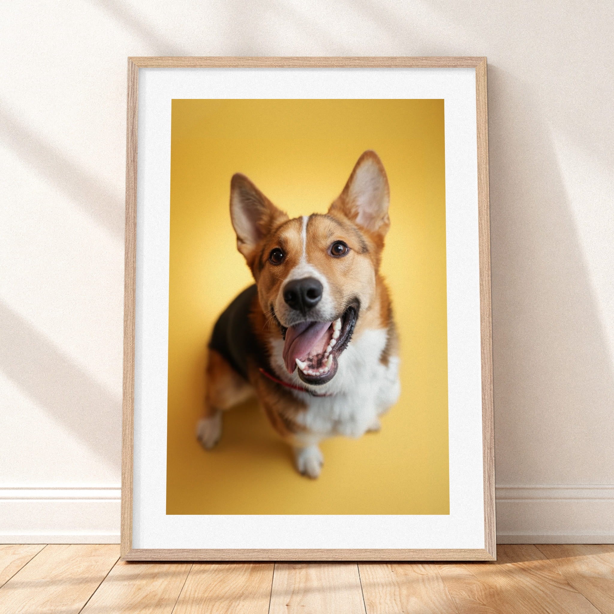 Framed mockup of The Statement Portrait — Butter by YOUNI.ONE. A bespoke vertical dog portrait set against a warm Butter studio backdrop, finished with a white gallery border and classic wood frame.