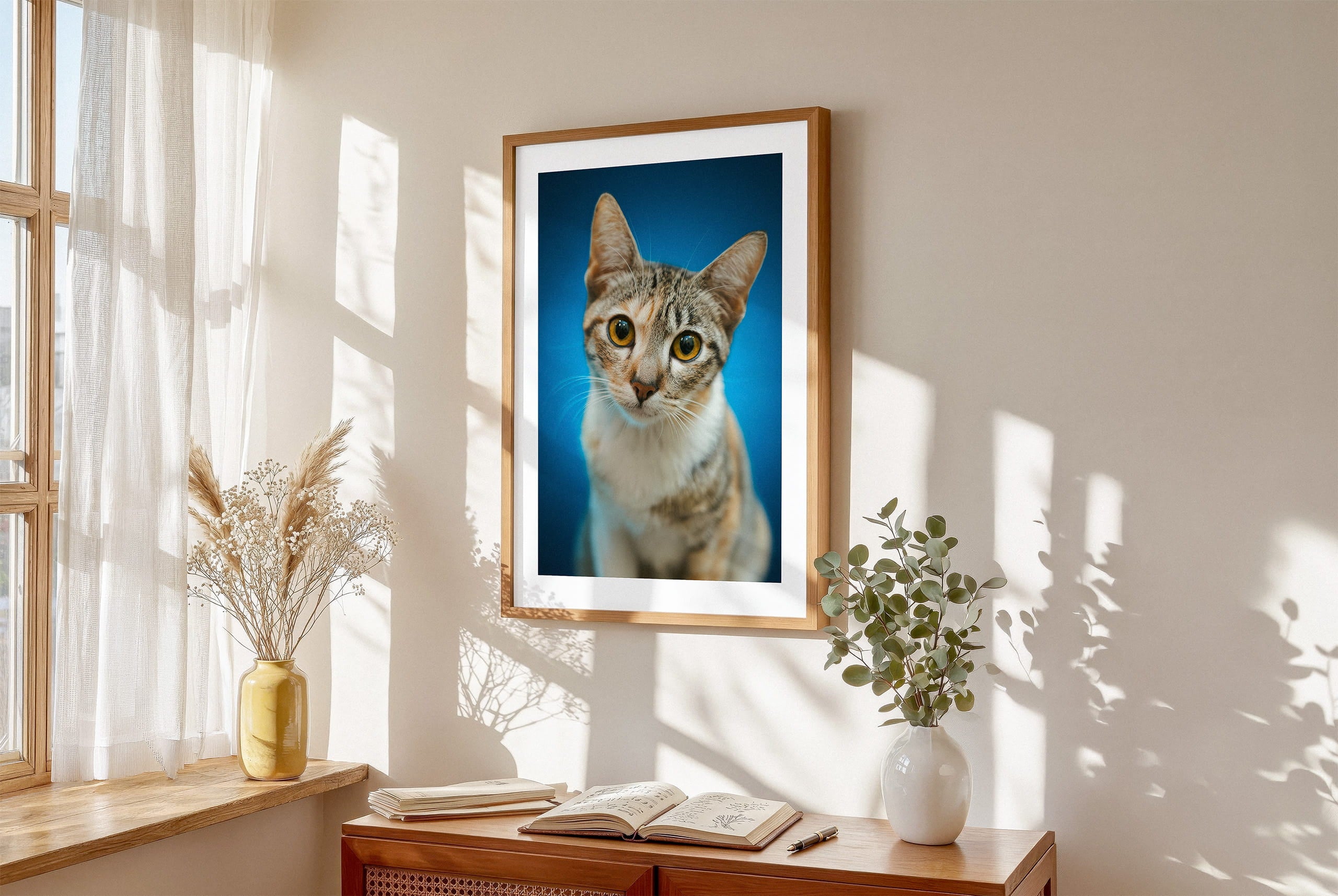 Framed lifestyle mockup of The Statement Portrait — Cerulean by YOUNI.ONE. A bespoke vertical dog portrait set against a vivid Cerulean studio backdrop, displayed as gallery-style wall art in a warm modern interior.