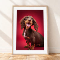 Framed mockup of The Statement Portrait - Ruby by YOUNI.ONE. A bespoke vertical dog portrait set against a bold Ruby studio backdrop, finished with a white gallery border and classic wood frame.